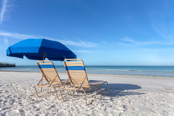 istock Two Beach Chairs with Umbrella on Beach 1145865172