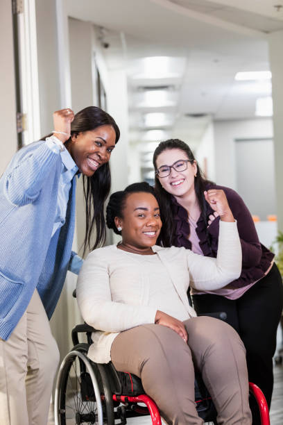 istock Women working together, one in wheelchair 1145865458