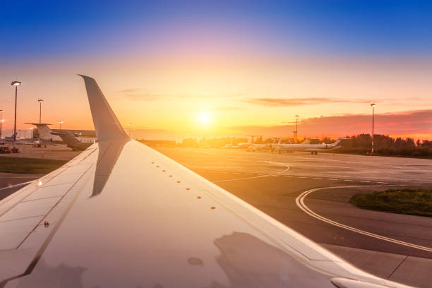 istock Evening dusk and sunset view with Wing of an airplane 1145866990