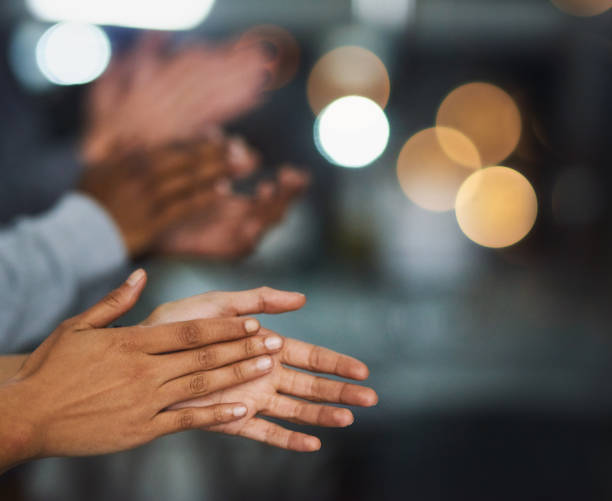 Cropped shot of a group of businesspeople applauding a business presentation