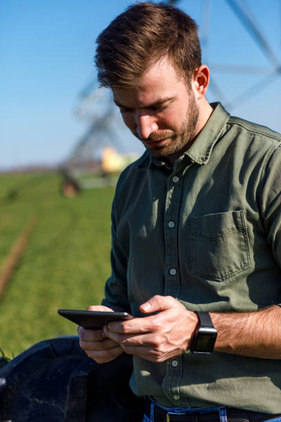 istock Young farmer standing in wheat field and setup irrigation system on tablet. 1145868898