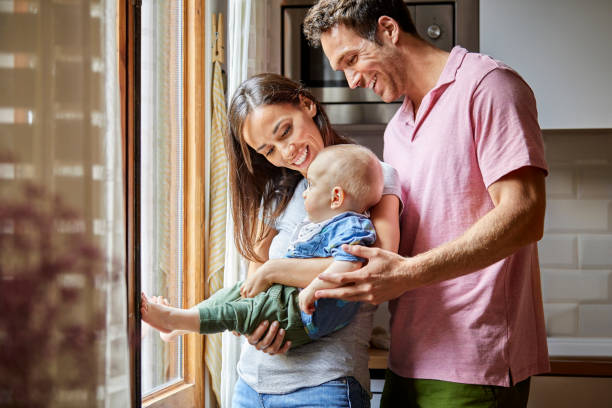 istock Smiling parents looking at toddler in sunlight 1145870031