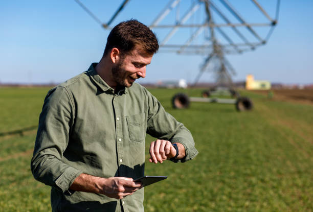 istock Young farmer standing in wheat field and setup irrigation system on tablet. 1145870575