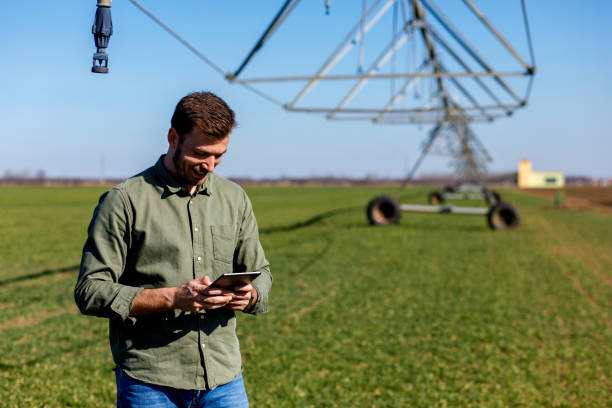 istock Young farmer standing in wheat field and setup irrigation system on tablet. 1145870641
