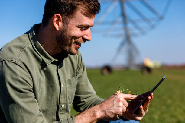 istock Young farmer standing in wheat field and setup irrigation system on tablet. 1145870701