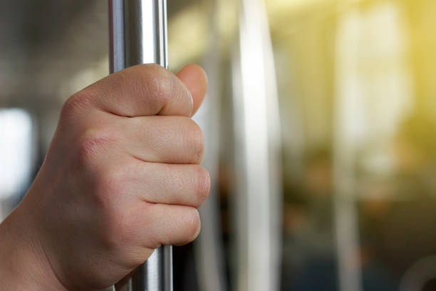 istock Man's hand holding a railing on a bus close-up 1145872292