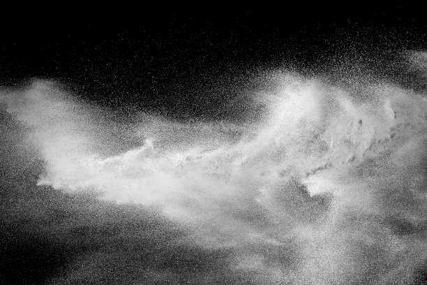istock Bizarre forms of white powder explosion cloud against black background.White dust particles splash. 1145874565