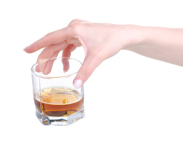 istock Glass with cognac brandy alcohol in hand 1145875182