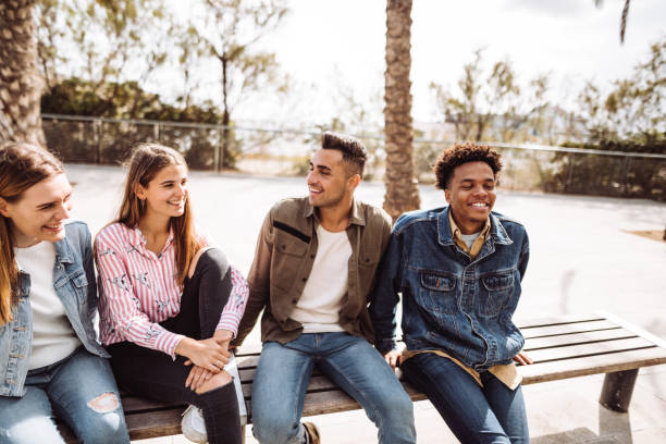 istock friends talking together on a bench 1145875408