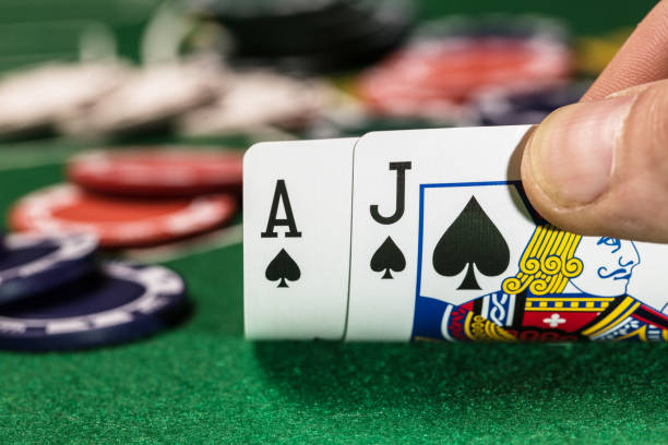 istock Casino background. Blackjack card game with chips on green table with copy space 1145875429