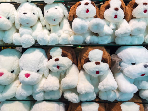istock Many white dog dolls in a shop. 1145875813