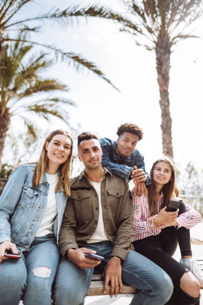 istock all together friends using mobile telephones 1145875946