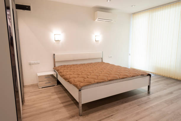 istock Simple bedroom interior with large comfortable bed. Interior photography 1145876920