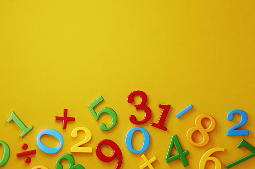 Colorful numbers on yellow background. Horizontal composition with  copy space. Directly above.