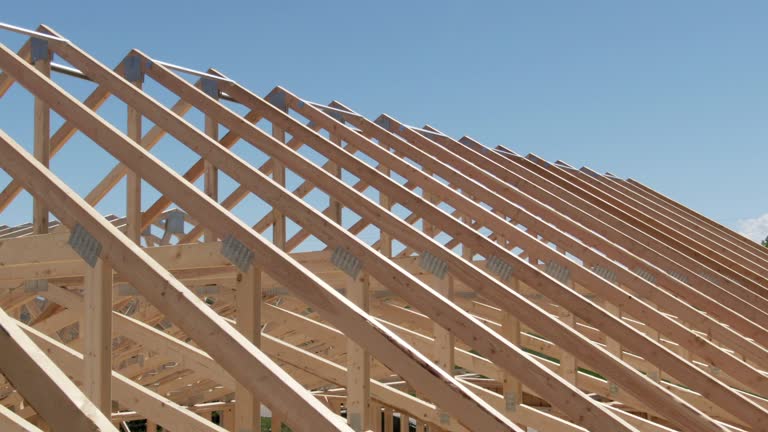 Aerial Drone Shot of a Row of Wooden Roof Trusses of a Framed House on a Construction Site on a Sunny Day