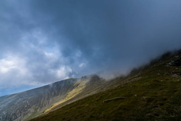 istock Dramatic cloudscape and mountain scenery in the Transylvanian Alps in summer, with rain clouds 1145880143