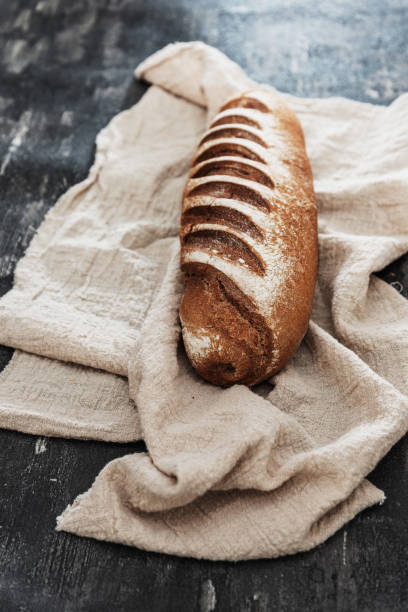 istock baked French bread on wooden table 1145880522