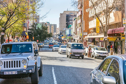 Kotze street view in Hillbrow Johannesburg with busy traffic.\nJohannesburg, also known as Jozi, Jo'burg or eGoli, \