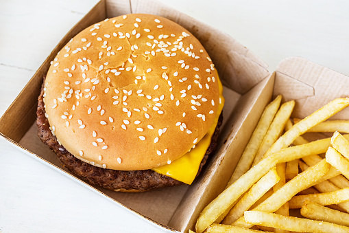 Fast food hamburger and chips in it's special cardboard box.