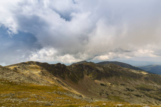 istock Dramatic cloudscape and mountain scenery in the Transylvanian Alps in summer, with rain clouds 1145881402