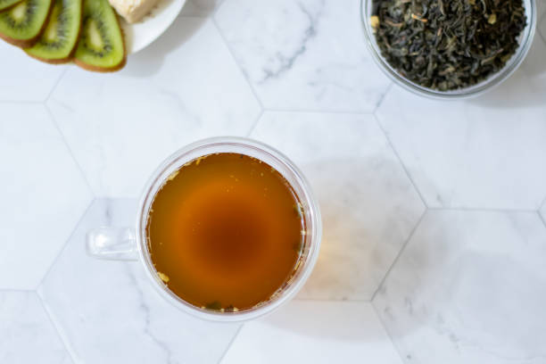istock Green tea with jasmine in a transparent mug on a light background. Horizontal orientation 1145882548