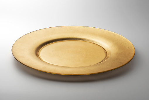 Empty Golden round flat plate isolated on white background