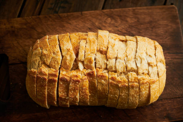 istock Loaf of sliced Sourdough bread on a rustic chopping board. 1145887649