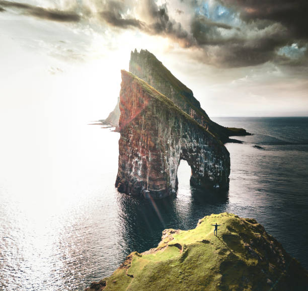 istock man with arm raisd camping at the faroe islands 1145891284