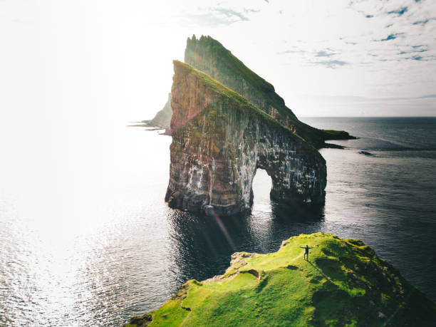 istock man with arm raisd camping at the faroe islands 1145891484