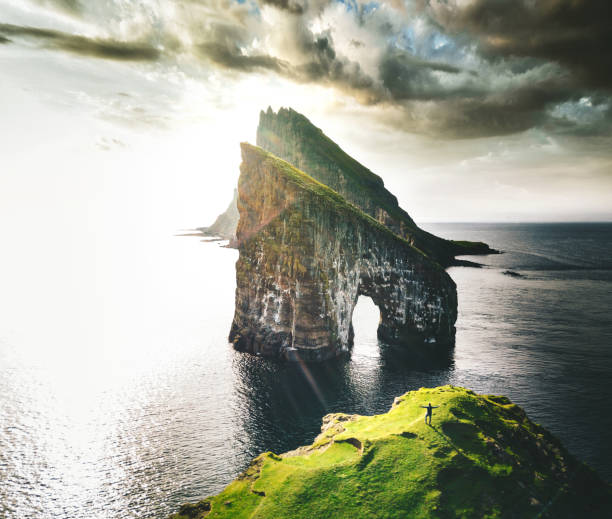 istock man with arm raisd camping at the faroe islands 1145891504