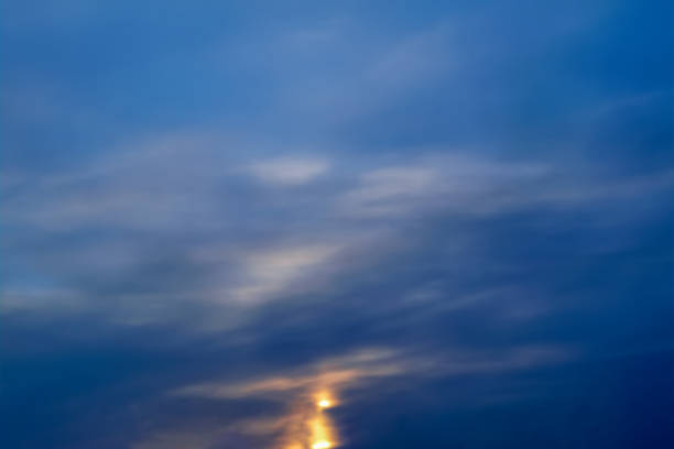 istock Blue sky with gold clouds - dramatic sunset, beautiful natural background. Setting sun illuminates the clouds. 1145898085