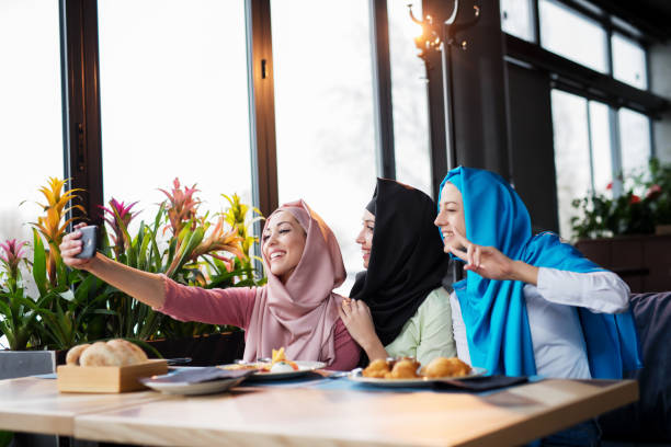 istock Group of islamic girls using smart phone 1145898812