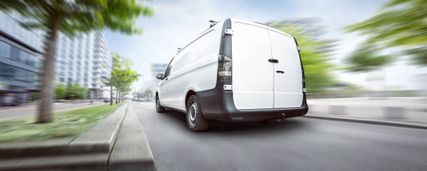 istock White commercial van driving in the city 1145899962