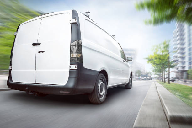 istock White van driving through the city at summertime 1145899964