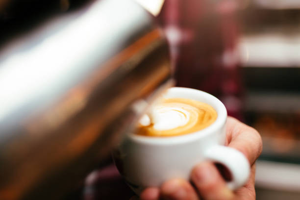 Barista making heart shape latte art coffee