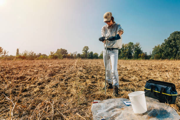 Soil Sampling. Woman Agronomist Taking Sample With Soil Probe Sampler Soil Sampling. Female agronomist taking sample with soil probe sampler. Environmental protection, organic soil certification, research specimen holder stock pictures, royalty-free photos & images