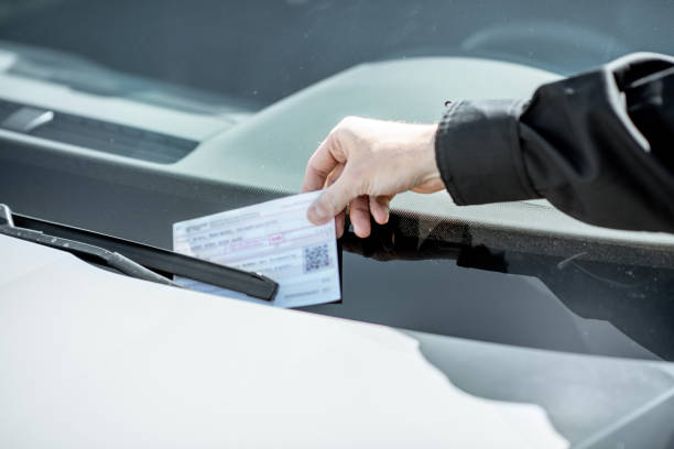 istock Policeman putting fine on the car 1145902547