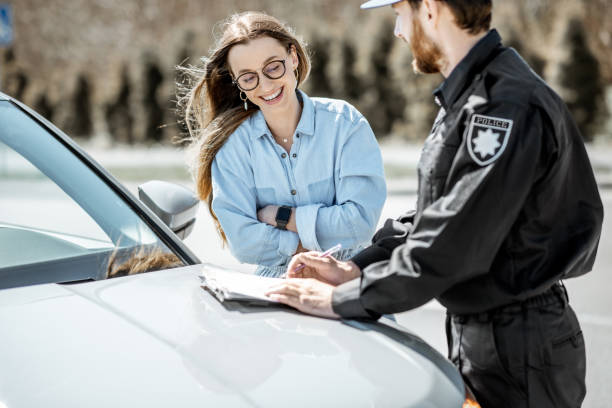 istock Policeman with female driver near the car 1145902559