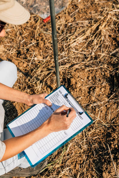 istock Soil Test. Female Agronomist Taking Notes In The Field 1145902600