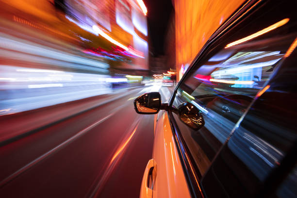 istock Speeding car driving in a night city. 1145902632