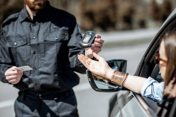 policeman checking woman driver for alcohol intoxication - intoxication imagens e fotografias de stock