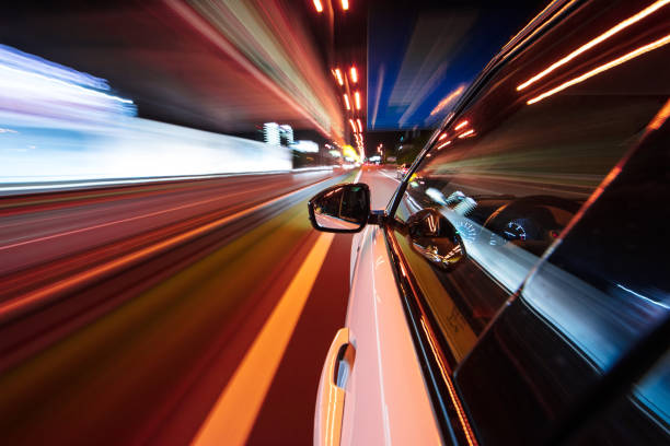 istock Speeding car driving in a night city. 1145902650