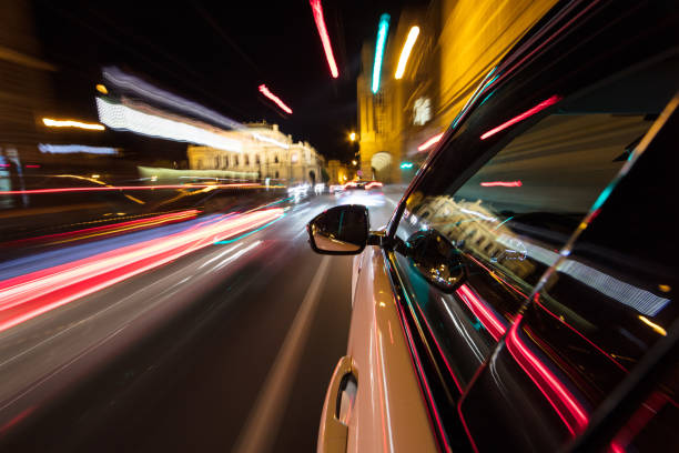 istock Speeding car driving in a night city. 1145902658