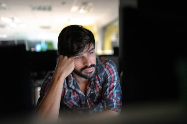 istock Tired businessman working late 1145903553