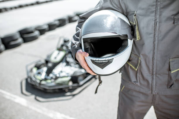 istock Racer with helmet on the go-kart track 1145903654