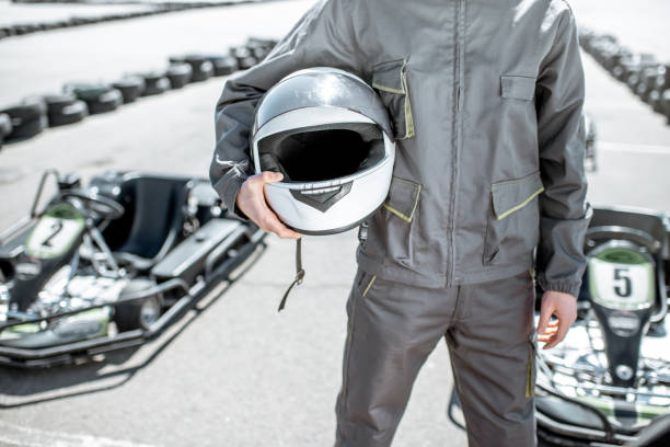 istock Racer with helmet on the go-kart track 1145903662