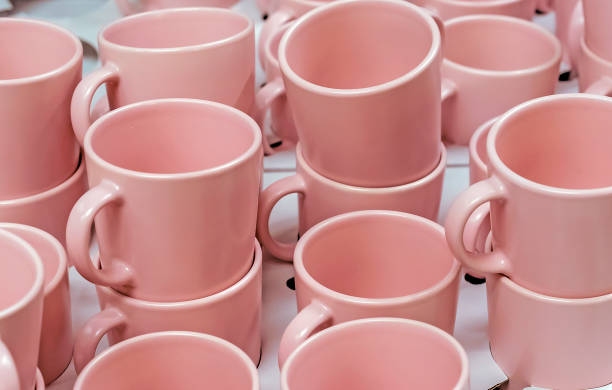 istock Pink ceramic mugs in a shop window. 1145903825