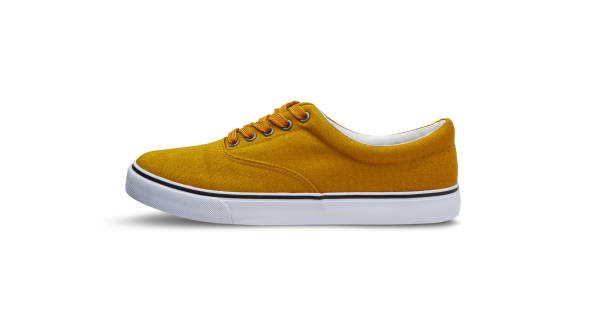 istock Yellow canvas shoes isolated on white background 1145904464