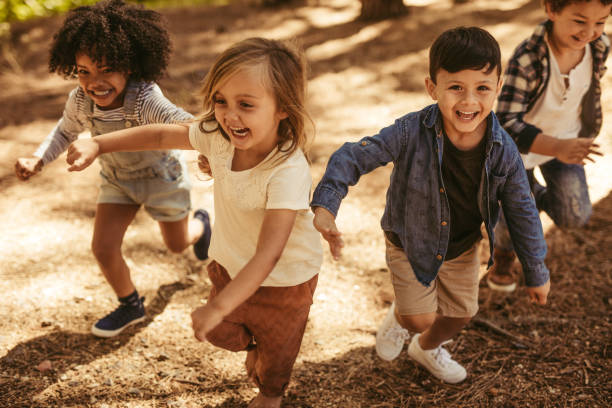 istock Children playing together in forest 1145906197