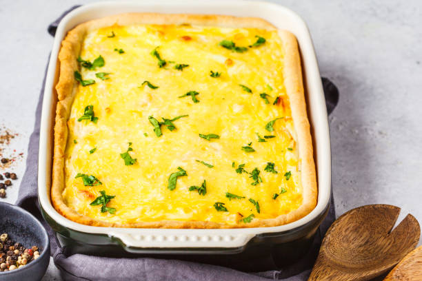 istock Quiche with cheese and greens in a black baking dish. 1145908211
